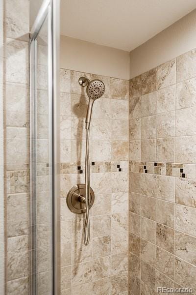 bathroom with a tile shower