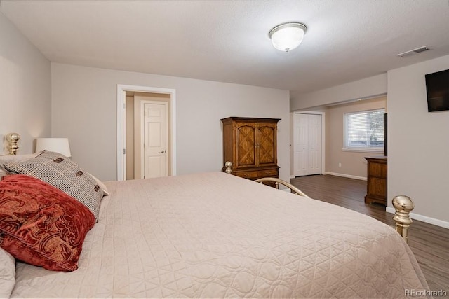 bedroom with dark wood-type flooring