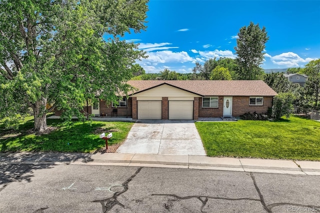11310 W 46th Ave, Wheat Ridge, CO 80033 - ranch-style home with brick siding, an attached garage, a front yard, and concrete driveway