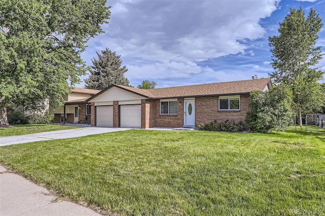 11310 W 46th Ave, Wheat Ridge, CO 80033 - view of front of home with brick siding, an attached garage, a front lawn, and concrete driveway