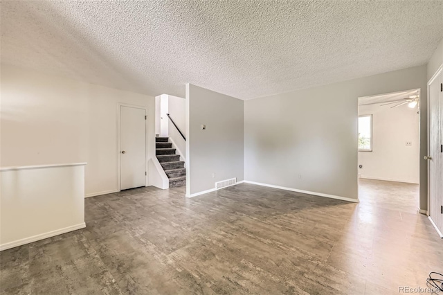 11310 W 46th Ave, Wheat Ridge, CO 80033 - unfurnished room with a textured ceiling, stairway, wood finished floors, baseboards, and ceiling fan