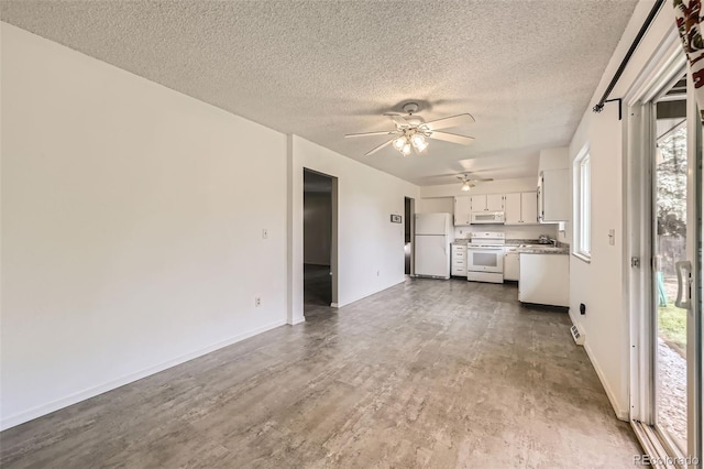 11310 W 46th Ave, Wheat Ridge, CO 80033 - unfurnished living room featuring ceiling fan, a textured ceiling, a sink, baseboards, and dark wood-style floors