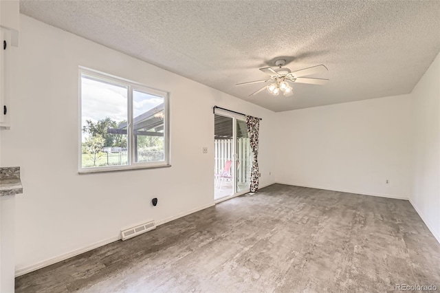 11310 W 46th Ave, Wheat Ridge, CO 80033 - spare room with a textured ceiling, a ceiling fan, and baseboards
