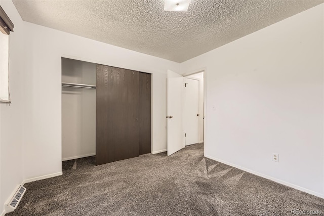11310 W 46th Ave, Wheat Ridge, CO 80033 - unfurnished bedroom with carpet floors, a closet, a textured ceiling, and baseboards