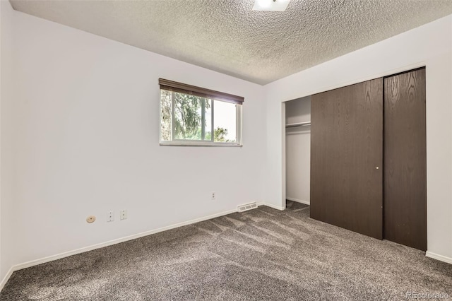 11310 W 46th Ave, Wheat Ridge, CO 80033 - unfurnished bedroom with dark carpet, a closet, a textured ceiling, and baseboards