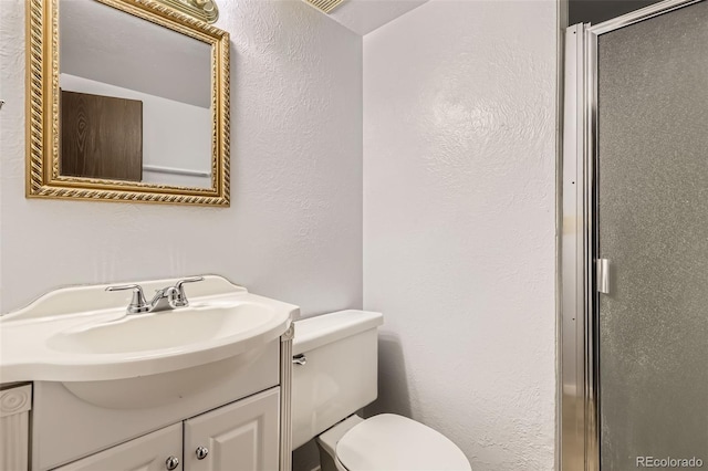 11310 W 46th Ave, Wheat Ridge, CO 80033 - full bath featuring toilet, vanity, a shower with shower door, and a textured wall