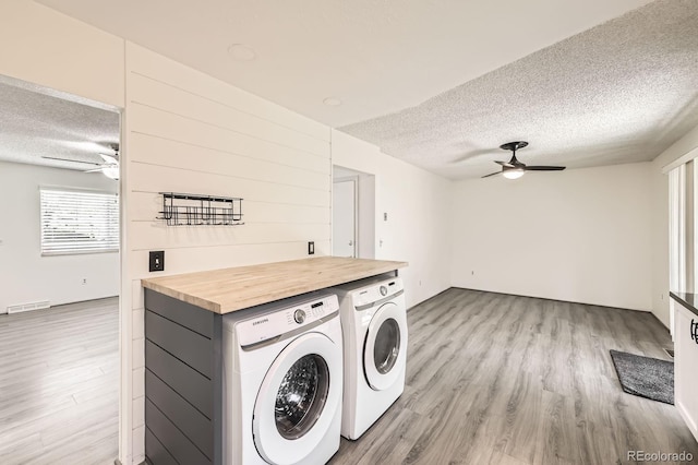 11310 W 46th Ave, Wheat Ridge, CO 80033 - washroom featuring a textured ceiling, a ceiling fan, light wood-style floors, and separate washer and dryer