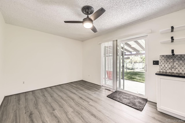 11310 W 46th Ave, Wheat Ridge, CO 80033 - doorway with a ceiling fan, a textured ceiling, and light wood finished floors