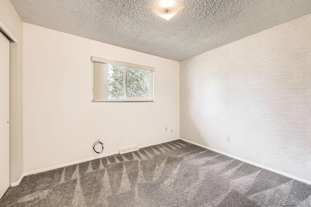 11310 W 46th Ave, Wheat Ridge, CO 80033 - unfurnished bedroom with carpet, a textured ceiling, baseboards, and a closet