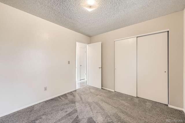 11310 W 46th Ave, Wheat Ridge, CO 80033 - unfurnished bedroom with carpet, a textured ceiling, a closet, and baseboards