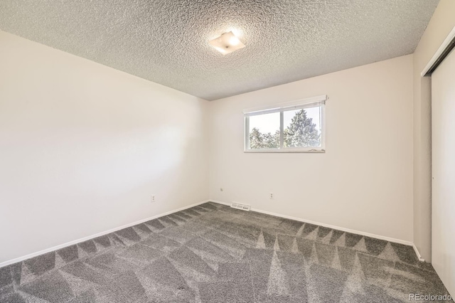 11310 W 46th Ave, Wheat Ridge, CO 80033 - unfurnished room with dark carpet, a textured ceiling, and baseboards