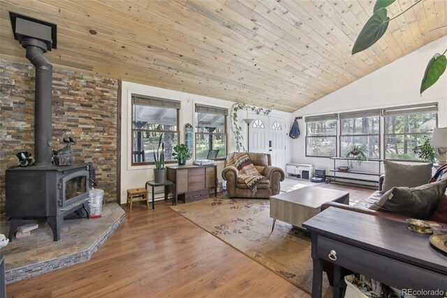 1021 Lodge Pole Dr, Black Hawk, CO 80422 - living room with a wood stove, wooden ceiling, wood finished floors, high vaulted ceiling, and a baseboard radiator