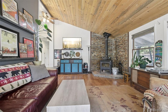 1021 Lodge Pole Dr, Black Hawk, CO 80422 - living area with vaulted ceiling, a wood stove, wood finished floors, wood ceiling, and a ceiling fan