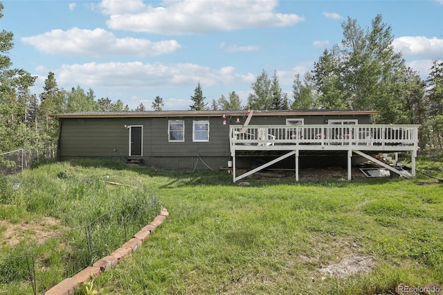 1021 Lodge Pole Dr, Black Hawk, CO 80422 - rear view of house with a deck and a lawn