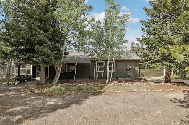 1021 Lodge Pole Dr, Black Hawk, CO 80422 - view of front of home featuring a garage, driveway, a shingled roof, and a porch