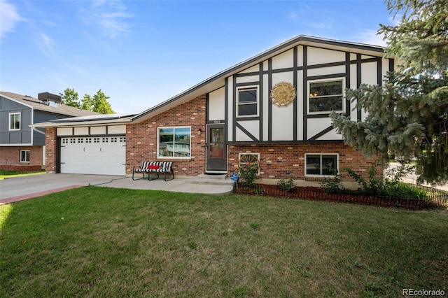 4501 S Garrison St, Littleton, CO 80123 - view of front of house featuring an attached garage, brick siding, driveway, a front lawn, and solar panels