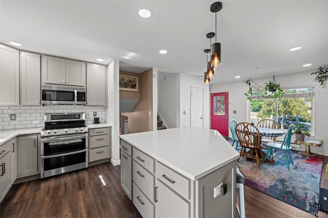 4501 S Garrison St, Littleton, CO 80123 - kitchen with stainless steel appliances, gray cabinetry, dark wood-style floors, plenty of natural light, and recessed lighting