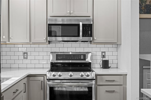 4501 S Garrison St, Littleton, CO 80123 - kitchen featuring appliances with stainless steel finishes, tasteful backsplash, and light countertops