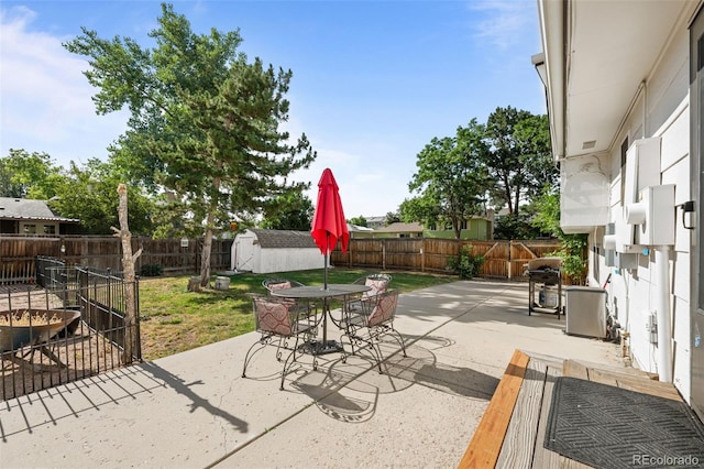 4501 S Garrison St, Littleton, CO 80123 - fenced backyard with a patio area, a storage shed, area for grilling, and outdoor dining space