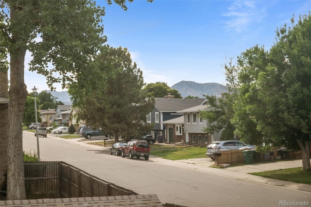 4501 S Garrison St, Littleton, CO 80123 - view of asphalt street featuring curbs, sidewalks, street lights, a mountain view, and a residential view