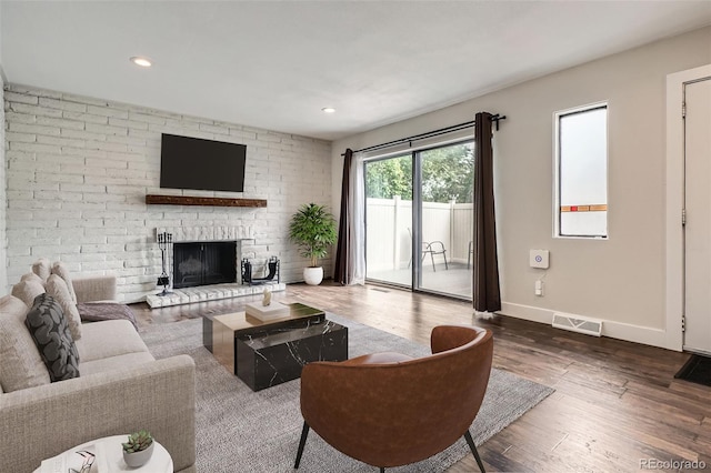 9605 E Kansas Cir Unit 53, Denver, CO 80247 - living area featuring wood finished floors, baseboards, a fireplace, and recessed lighting