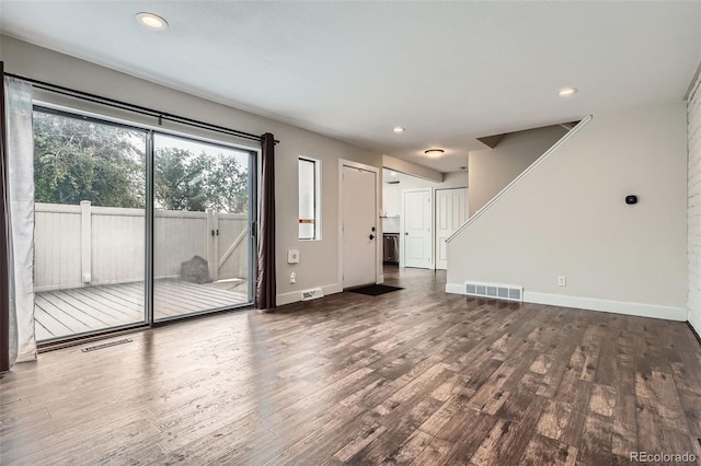 9605 E Kansas Cir Unit 53, Denver, CO 80247 - unfurnished living room featuring wood finished floors, baseboards, recessed lighting, and stairway