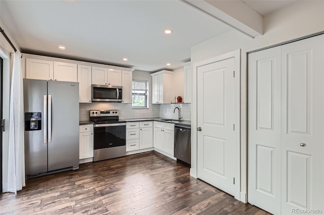 9605 E Kansas Cir Unit 53, Denver, CO 80247 - kitchen featuring stainless steel appliances, a sink, decorative backsplash, dark wood finished floors, and dark countertops