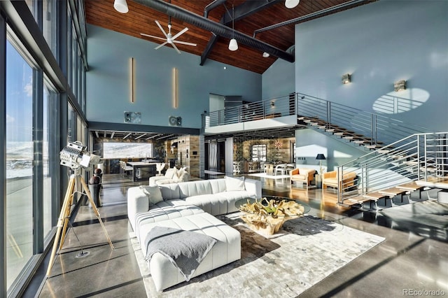 living area featuring wooden ceiling, a high ceiling, and beam ceiling