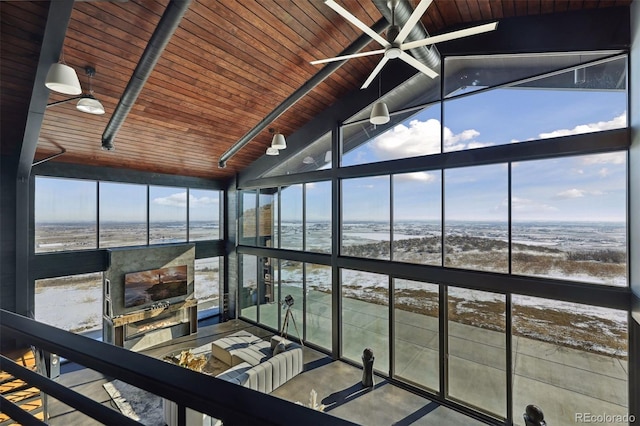 unfurnished sunroom with vaulted ceiling with beams, a wealth of natural light, and wood ceiling