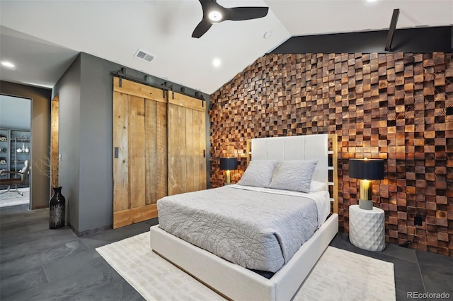 bedroom with lofted ceiling, ceiling fan, a barn door, visible vents, and a closet