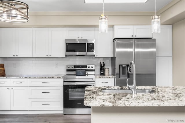 21535 E 39th Ave, Denver, CO 80249 - kitchen with appliances with stainless steel finishes, white cabinetry, tasteful backsplash, and light stone countertops