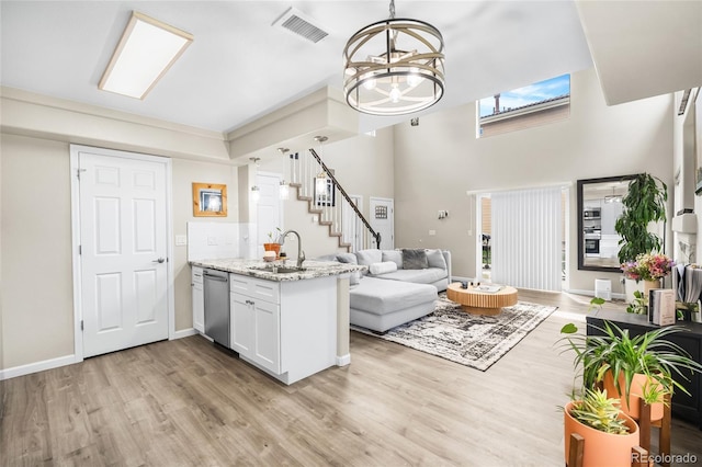 21535 E 39th Ave, Denver, CO 80249 - kitchen with open floor plan, a peninsula, dishwasher, and light wood-type flooring