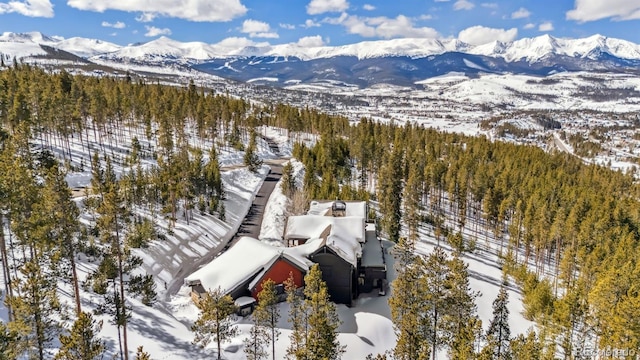 snowy aerial view featuring a mountain view