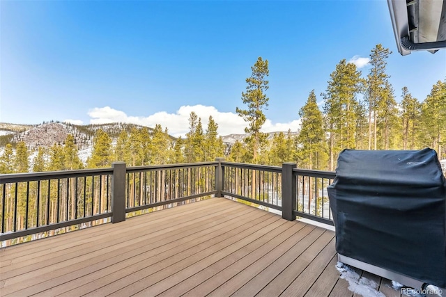 deck with grilling area and a mountain view