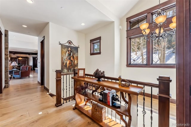 hallway with recessed lighting, light wood-style flooring, an upstairs landing, a chandelier, and baseboards