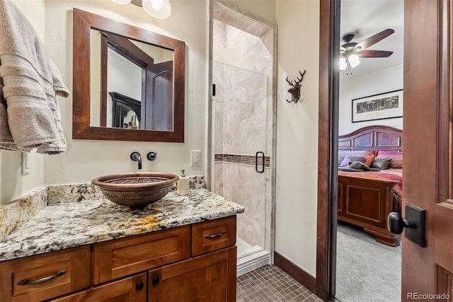 bathroom featuring ensuite bathroom, a ceiling fan, vanity, baseboards, and a shower stall