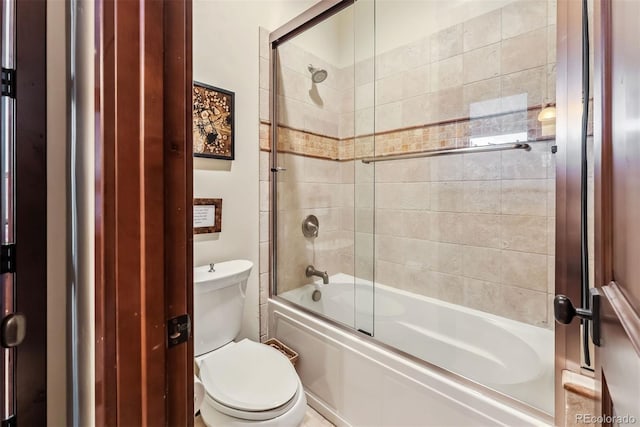 full bathroom with combined bath / shower with glass door and toilet