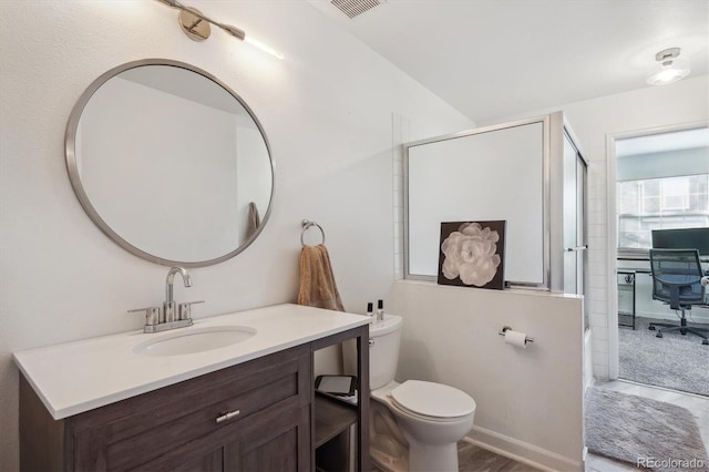 bathroom with toilet, visible vents, combined bath / shower with glass door, and vanity