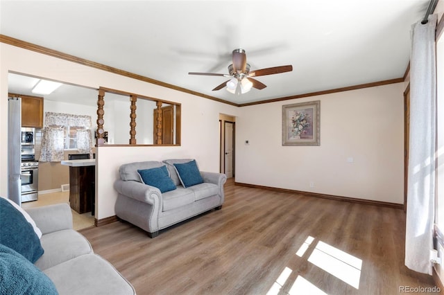 6981 Zuni St, Denver, CO 80221 - living room with baseboards, ceiling fan, ornamental molding, and light wood-style flooring