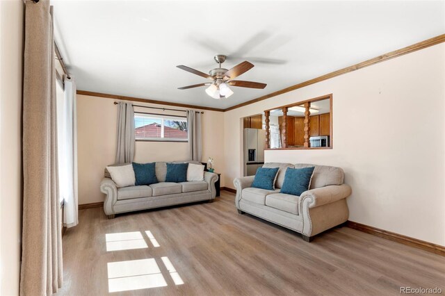 6981 Zuni St, Denver, CO 80221 - living area with baseboards, ornamental molding, light wood finished floors, and ceiling fan