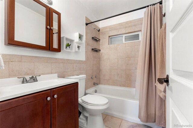 6981 Zuni St, Denver, CO 80221 - bathroom with vanity, toilet, tile walls, tile patterned floors, and shower / bath combo