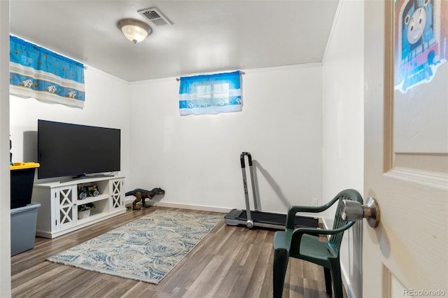 6981 Zuni St, Denver, CO 80221 - exercise room with baseboards, wood finished floors, and visible vents