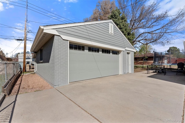 6981 Zuni St, Denver, CO 80221 - detached garage featuring fence and a trampoline