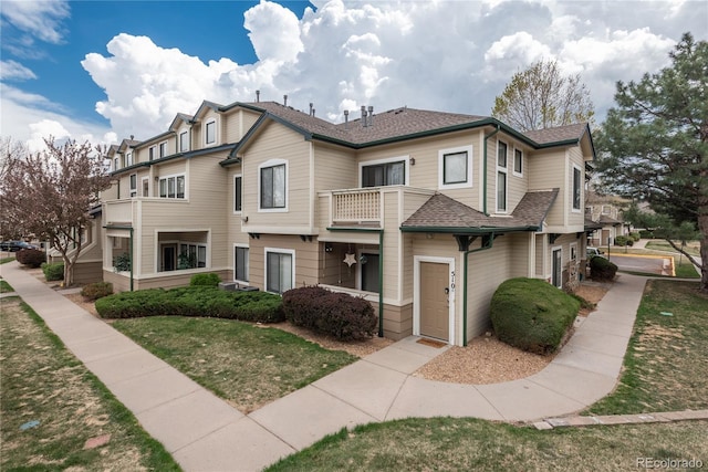 8707 E Florida Ave Unit 510, Denver, CO 80247 - townhome / multi-family property featuring a front lawn, roof with shingles, and a balcony