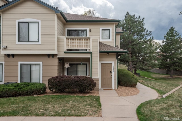 8707 E Florida Ave Unit 510, Denver, CO 80247 - view of front of property with roof with shingles, a balcony, and a front yard