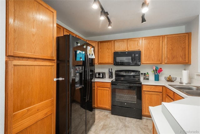 8707 E Florida Ave Unit 510, Denver, CO 80247 - kitchen featuring light countertops, a sink, and black appliances