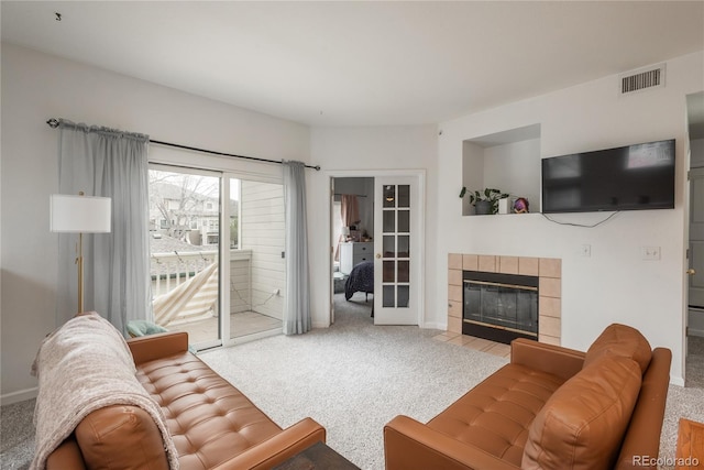 8707 E Florida Ave Unit 510, Denver, CO 80247 - living room with carpet floors, baseboards, a fireplace, and visible vents