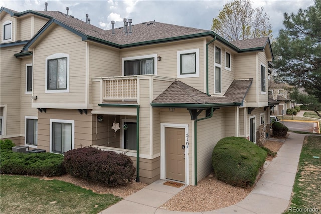 8707 E Florida Ave Unit 510, Denver, CO 80247 - view of front of property with roof with shingles, central AC unit, and a balcony