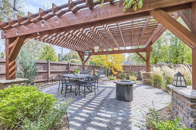 view of patio with a pergola and a fire pit