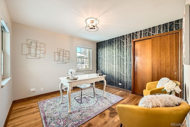 office space featuring an inviting chandelier and light wood-type flooring